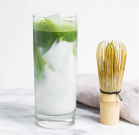 Creamy drink with whisk beside it